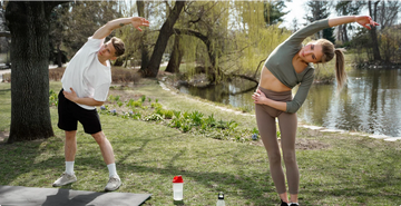 man and a women doing yoga outside